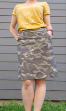 Load image into Gallery viewer, Model wearing knee length, camo printed pencil skirt with pockets, and a yellow tee shirt.
